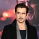 Colin Farrell in front of The Penguin poster